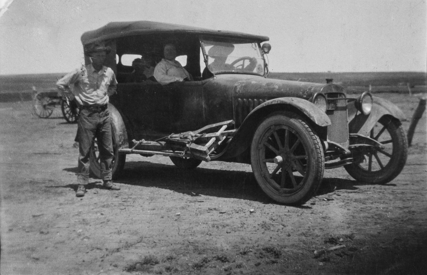 Several Men pose in Automobile